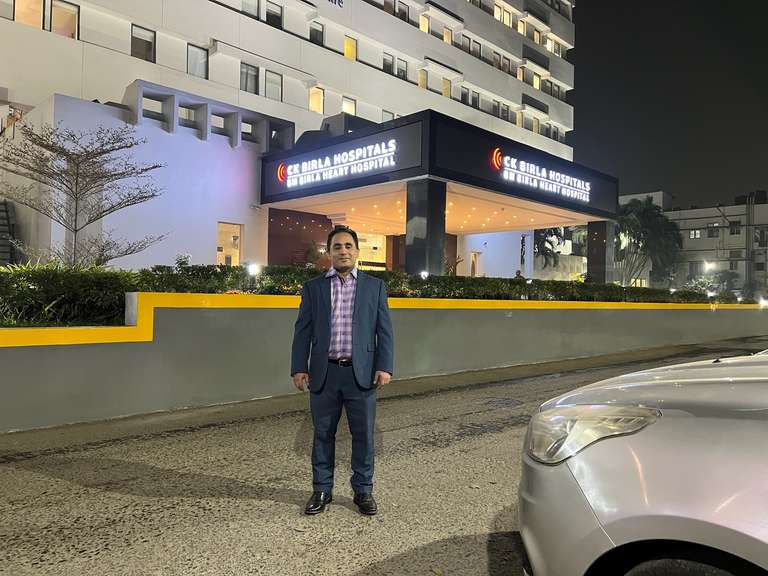 Dr Joy Shome standing outside BM Birla Hospital's foyer